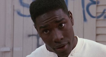 Movie still from “Boyz n the Hood” (1991), directed by John Singleton – A person with a white shirt; Close Up shot, High angle