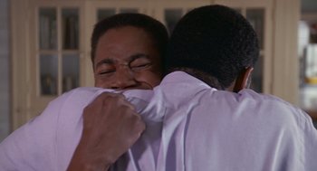 Movie still from “Boyz n the Hood” (1991), directed by John Singleton – Two men hugging and smiling for the camera; Close Up shot, Over the shoulder angle
