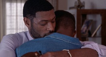 Movie still from “Boyz n the Hood” (1991), directed by John Singleton – A person hugging a person; Close Up shot, Over the shoulder angle