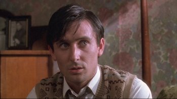 Movie still from “Dead Alive” (1992), directed by Peter Jackson – A person wearing a vest; Close Up shot, Low angle