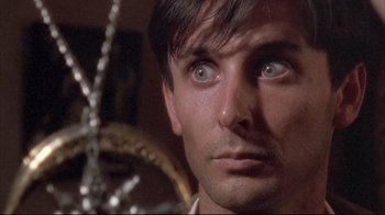 Movie still from “Dead Alive” (1992), directed by Peter Jackson – A close up picture of a man's face; Close Up shot, Low angle