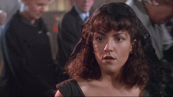 Movie still from “Dead Alive” (1992), directed by Peter Jackson – A person wearing a hat; Close Up shot, Over the shoulder angle