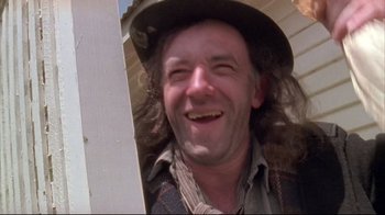 Movie still from “Dead Alive” (1992), directed by Peter Jackson – A person wearing a hat; Close Up shot, Low angle