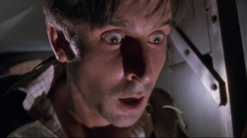 Movie still from “Dead Alive” (1992), directed by Peter Jackson – A man's face as he stares into the camera; Close Up shot, Low angle