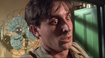 Movie still from “Dead Alive” (1992), directed by Peter Jackson – A person looking at the camera; Close Up shot, Low angle