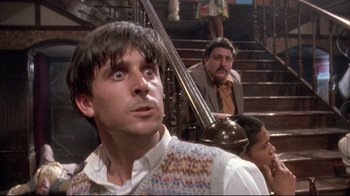Movie still from “Dead Alive” (1992), directed by Peter Jackson – A group of people sitting on some stairs; Close Up shot, Low angle