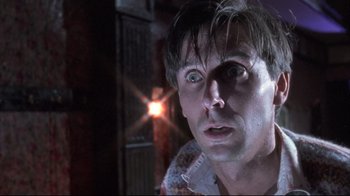 Movie still from “Dead Alive” (1992), directed by Peter Jackson – A person with eyes wide open; Close Up shot, Low angle