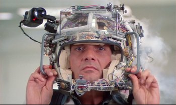 Movie still from “Brainstorm” (1983), directed by Douglas Trumbull – A man wearing a helmet made out of wires and electronics; Close Up shot, Overhead angle