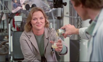 Movie still from “Brainstorm” (1983), directed by Douglas Trumbull – A man pouring a drink into a woman's hand; Medium shot, Over the shoulder angle