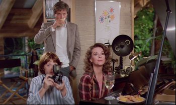 Movie still from “Brainstorm” (1983), directed by Douglas Trumbull – A group of people sitting at a table with wine glasses; Medium shot, Over the shoulder angle