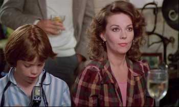 Movie still from “Brainstorm” (1983), directed by Douglas Trumbull – A woman and a boy sitting in front of another woman; Medium shot, Over the shoulder angle