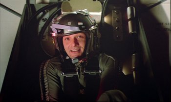 Movie still from “Brainstorm” (1983), directed by Douglas Trumbull – A man wearing a helmet sitting in the cockpit of an airplane; Close Up shot, High angle