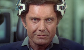 Movie still from “Brainstorm” (1983), directed by Douglas Trumbull – A person wearing a headset on their head; Close Up shot, High angle