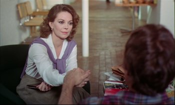 Movie still from “Brainstorm” (1983), directed by Douglas Trumbull – A woman sitting on the ground talking to a man; Medium shot, Over the shoulder angle