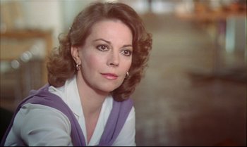 Movie still from “Brainstorm” (1983), directed by Douglas Trumbull – A person with curly hair wearing a dress; Close Up shot, Over the shoulder angle