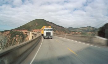 Movie still from “Brainstorm” (1983), directed by Douglas Trumbull – A truck driving down a road near a bridge; Extreme Wide shot, High angle