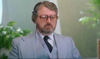Movie still from “Brainstorm” (1983), directed by Douglas Trumbull – An older man wearing a suit and tie; Close Up shot, Over the shoulder angle