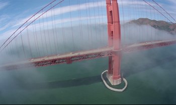 Movie still from “Brainstorm” (1983), directed by Douglas Trumbull – A view of the golden gate bridge from a helicopter; Extreme Wide shot, Overhead angle