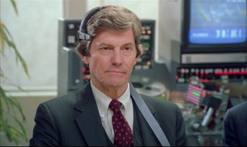 Movie still from “Brainstorm” (1983), directed by Douglas Trumbull – An older man wearing a suit and tie; Close Up shot, Over the shoulder angle