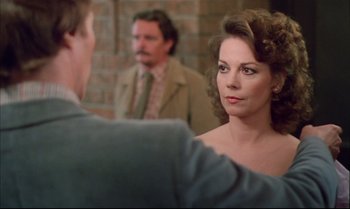 Movie still from “Brainstorm” (1983), directed by Douglas Trumbull – A man and a woman in front of a brick wall; Close Up shot, Over the shoulder angle