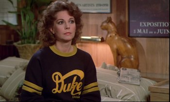 Movie still from “Brainstorm” (1983), directed by Douglas Trumbull – A woman sitting in front of a horse statue; Medium shot, Over the shoulder angle