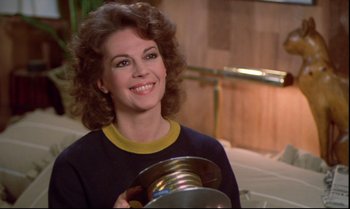 Movie still from “Brainstorm” (1983), directed by Douglas Trumbull – A smiling woman holding a tin can in her hands; Close Up shot, Over the shoulder angle