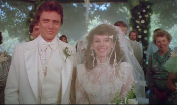 Movie still from “Brainstorm” (1983), directed by Douglas Trumbull – A man and a woman standing next to each other in front of trees; Close Up shot, Low angle