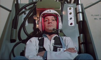 Movie still from “Brainstorm” (1983), directed by Douglas Trumbull – A man wearing a helmet sitting in an airplane cockpit; Medium shot, Low angle