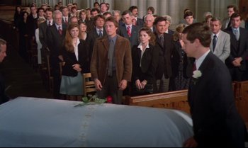Movie still from “Brainstorm” (1983), directed by Douglas Trumbull – A group of people standing in front of a casket; Wide shot, High angle
