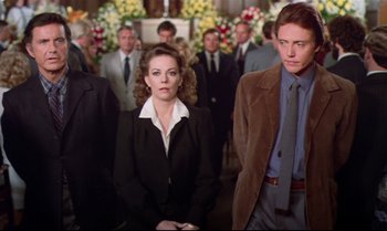 Movie still from “Brainstorm” (1983), directed by Douglas Trumbull – A group of people standing in front of a crowd; Medium shot, Low angle