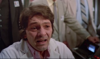 Movie still from “Brainstorm” (1983), directed by Douglas Trumbull – A man in a white lab coat is crying; Close Up shot, Over the shoulder angle
