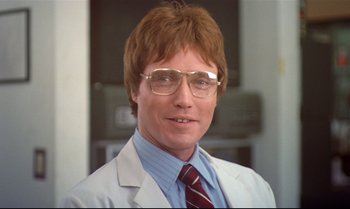 Movie still from “Brainstorm” (1983), directed by Douglas Trumbull – A person wearing glasses and a suit; Close Up shot, Low angle