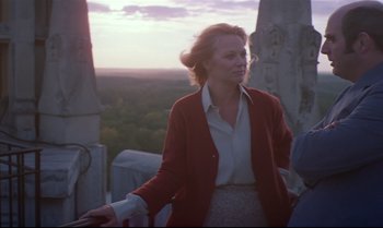 Movie still from “Brainstorm” (1983), directed by Douglas Trumbull – A woman standing on top of a building near trees; Medium shot, Low angle