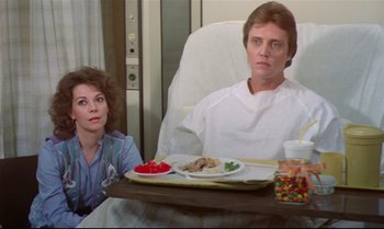 Movie still from “Brainstorm” (1983), directed by Douglas Trumbull – A man and a woman sitting at a table with a plate of food on it; Medium shot, Over the shoulder angle