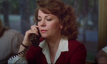 Movie still from “Brainstorm” (1983), directed by Douglas Trumbull – A woman talking on a phone while sitting down; Close Up shot, Low angle