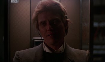 Movie still from “Brainstorm” (1983), directed by Douglas Trumbull – A man wearing a headset in a dimly - lit room; Close Up shot, Low angle