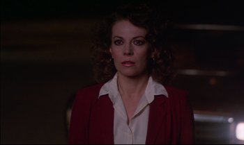 Movie still from “Brainstorm” (1983), directed by Douglas Trumbull – A person wearing a suit and tie; Close Up shot, Over the shoulder angle