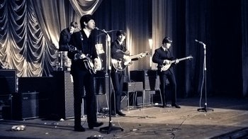 Movie still from “The Beatles: Eight Days a Week - The Touring Years” (2016), directed by Ron Howard – A group of people that are on a stage; Wide shot, High angle