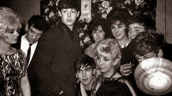 Movie still from “The Beatles: Eight Days a Week - The Touring Years” (2016), directed by Ron Howard – A group of young people posing for a picture; Medium shot, Overhead angle
