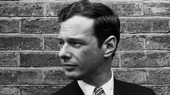 Movie still from “The Beatles: Eight Days a Week - The Touring Years” (2016), directed by Ron Howard – Black and white photograph of a man wearing a suit and tie; Close Up shot, Low angle