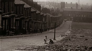 Movie still from “The Beatles: Eight Days a Week - The Touring Years” (2016), directed by Ron Howard – Two children playing on the side of the street; Extreme Wide shot, High angle