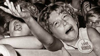 Movie still from “The Beatles: Eight Days a Week - The Touring Years” (2016), directed by Ron Howard – An old photo of a child crying in a crowd; Close Up shot, High angle