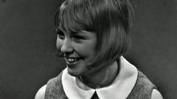 Movie still from “The Beatles: Eight Days a Week - The Touring Years” (2016), directed by Ron Howard – A young woman with short brown hair wearing a collared shirt; Close Up shot, Low angle