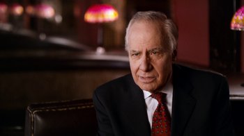 Movie still from “The Beatles: Eight Days a Week - The Touring Years” (2016), directed by Ron Howard – An older man wearing a suit and tie; Close Up shot, Over the shoulder angle