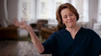 Movie still from “The Beatles: Eight Days a Week - The Touring Years” (2016), directed by Ron Howard – A woman in a blue shirt is holding her arm up; Medium shot, Low angle