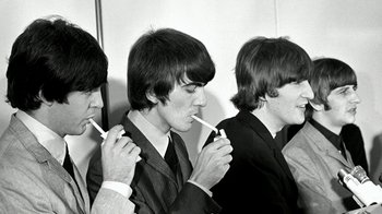 Movie still from “The Beatles: Eight Days a Week - The Touring Years” (2016), directed by Ron Howard – A black and white photo of three young men smoking; Close Up shot, High angle
