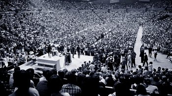 Movie still from “The Beatles: Eight Days a Week - The Touring Years” (2016), directed by Ron Howard – A large crowd of people in a stadium; Extreme Wide shot, High angle