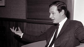 Movie still from “The Beatles: Eight Days a Week - The Touring Years” (2016), directed by Ron Howard – A black and white photo of a man wearing a suit and tie; Close Up shot, Over the shoulder angle