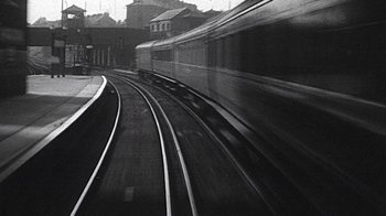 Movie still from “The Beatles: Eight Days a Week - The Touring Years” (2016), directed by Ron Howard – Black and white photograph of a train on the tracks; Wide shot, Low angle