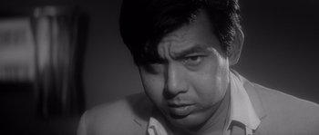 Black and white photograph of a man looking sad